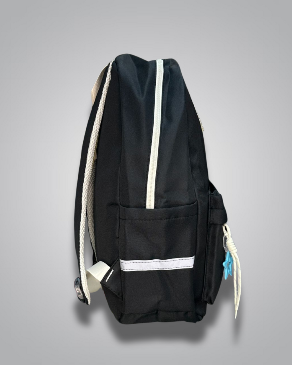 Black backpack with decorative patches and a blue star charm on a gray background- Valentino Impex