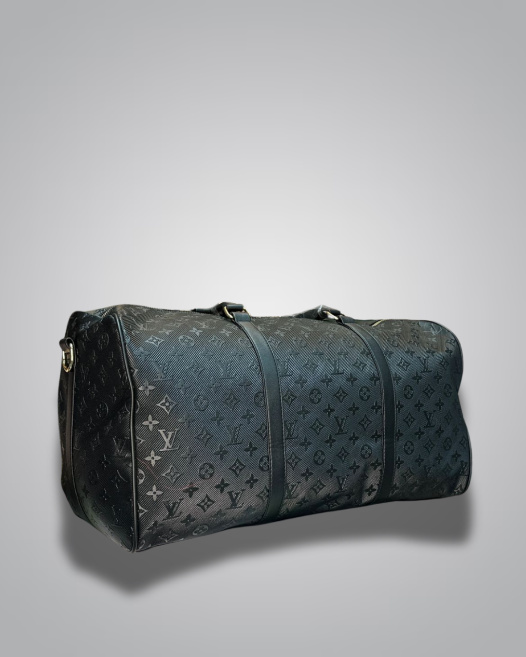 Blue duffel bag with monogram pattern on a gray background