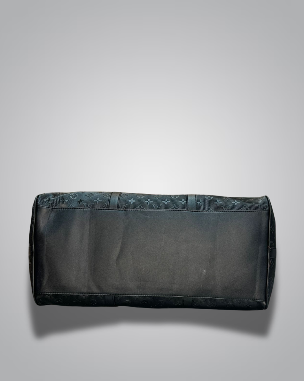 Black duffel bag with floral pattern on a gray background