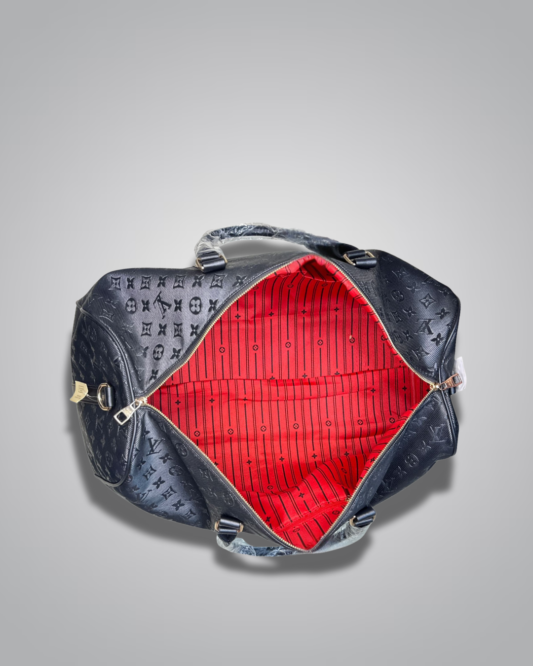 Black textured bag with red interior on a gray background