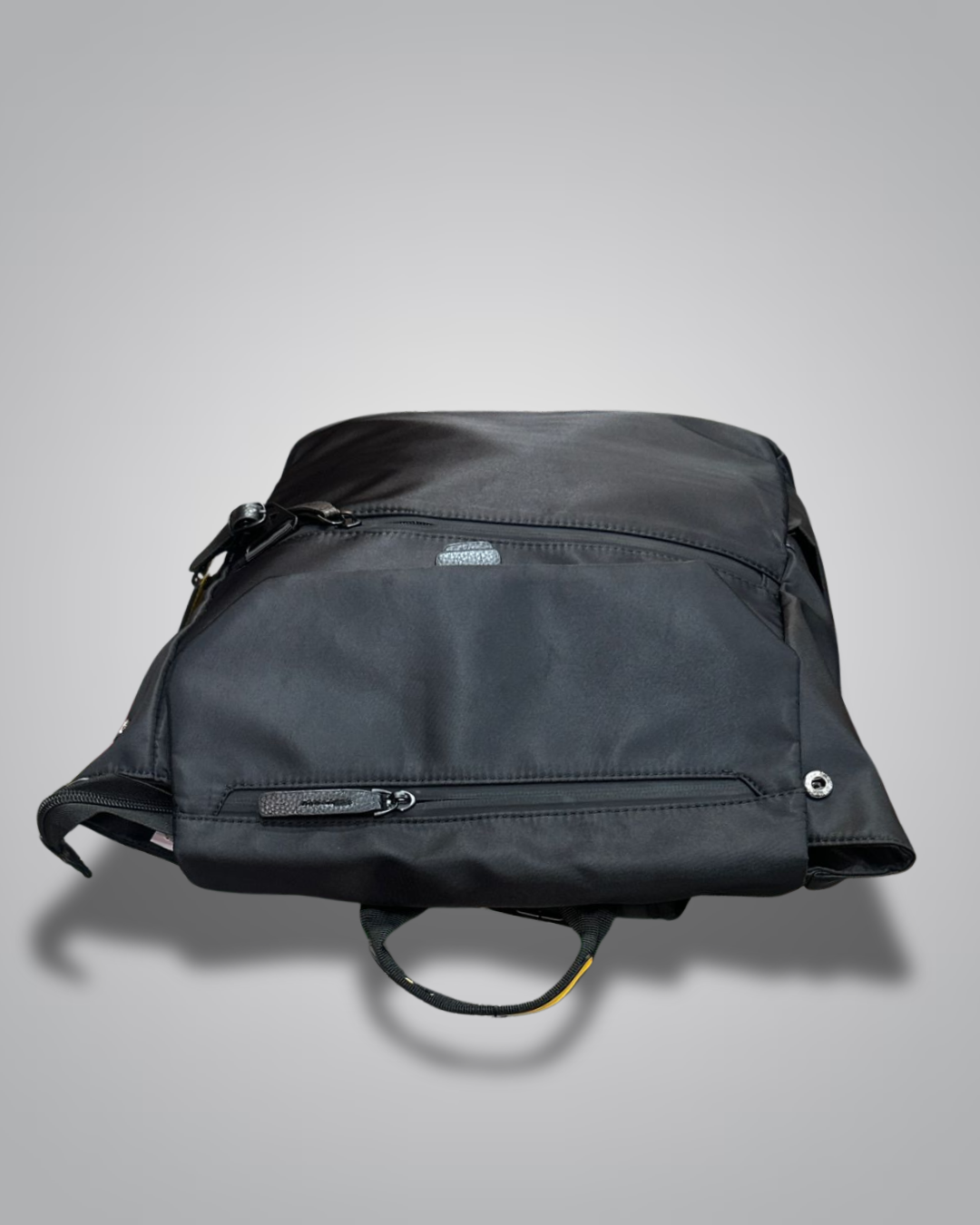 Black backpack with yellow accents on a gray background- Valentino Impex