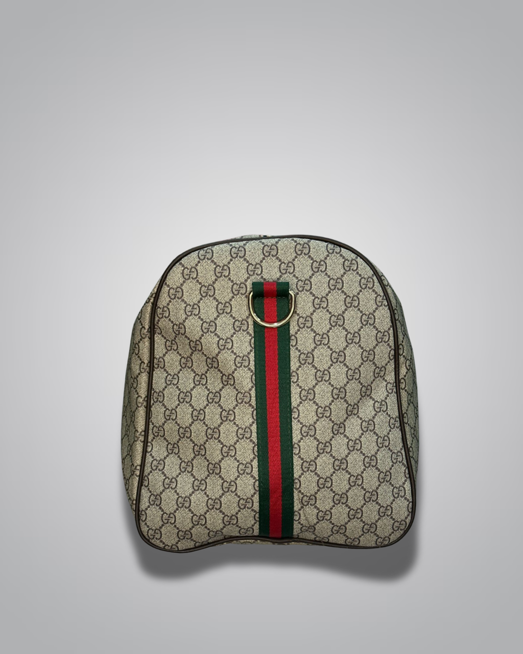 Gucci backpack with monogram pattern and green and red stripe on a light gray background