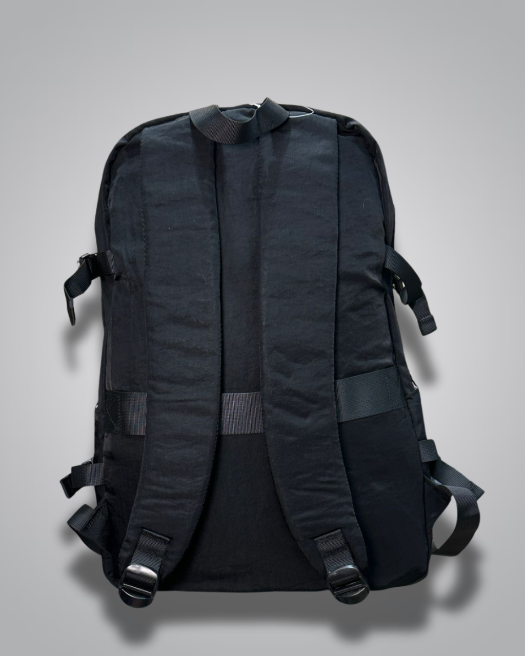 Black backpack with a visible brand label on a gray background- Valentino Impex