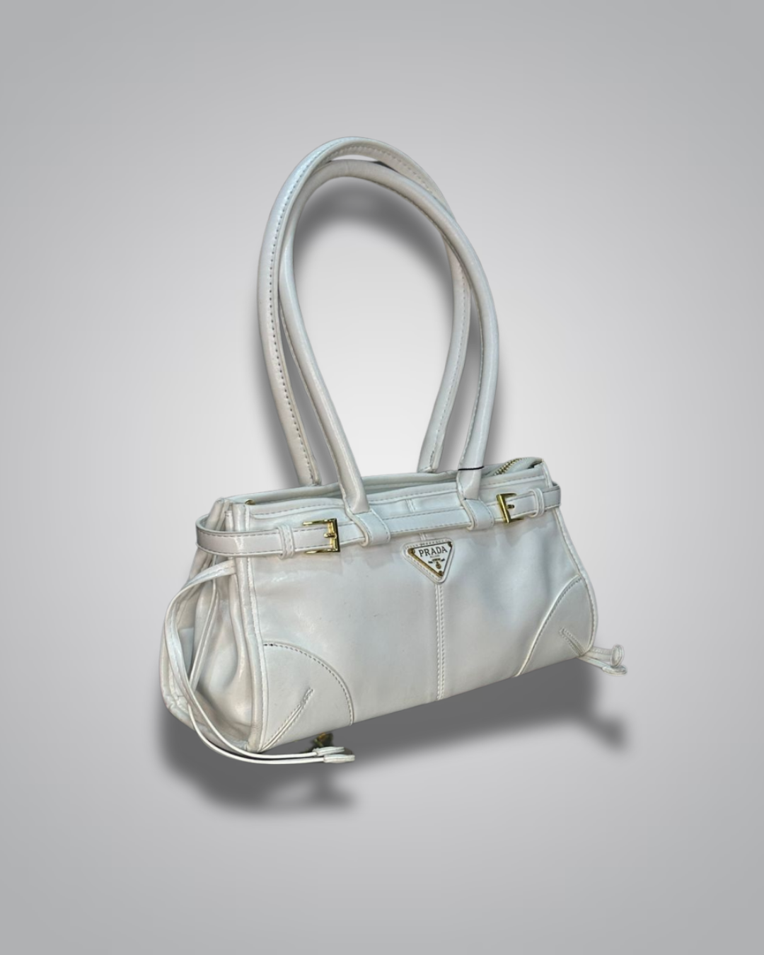 White handbag with a Prada logo on a light gray background