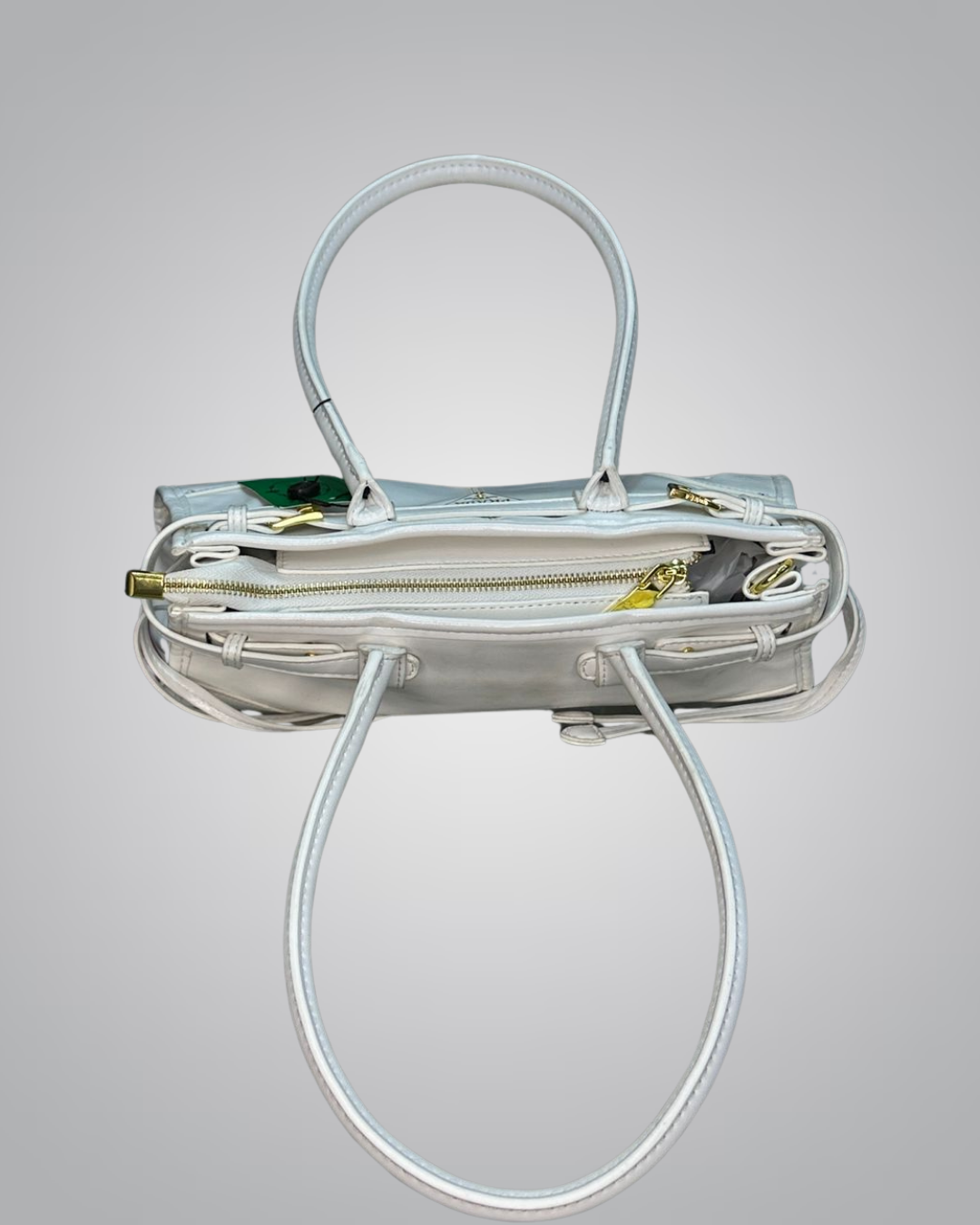 Clear handbag with gold accents on a gray background