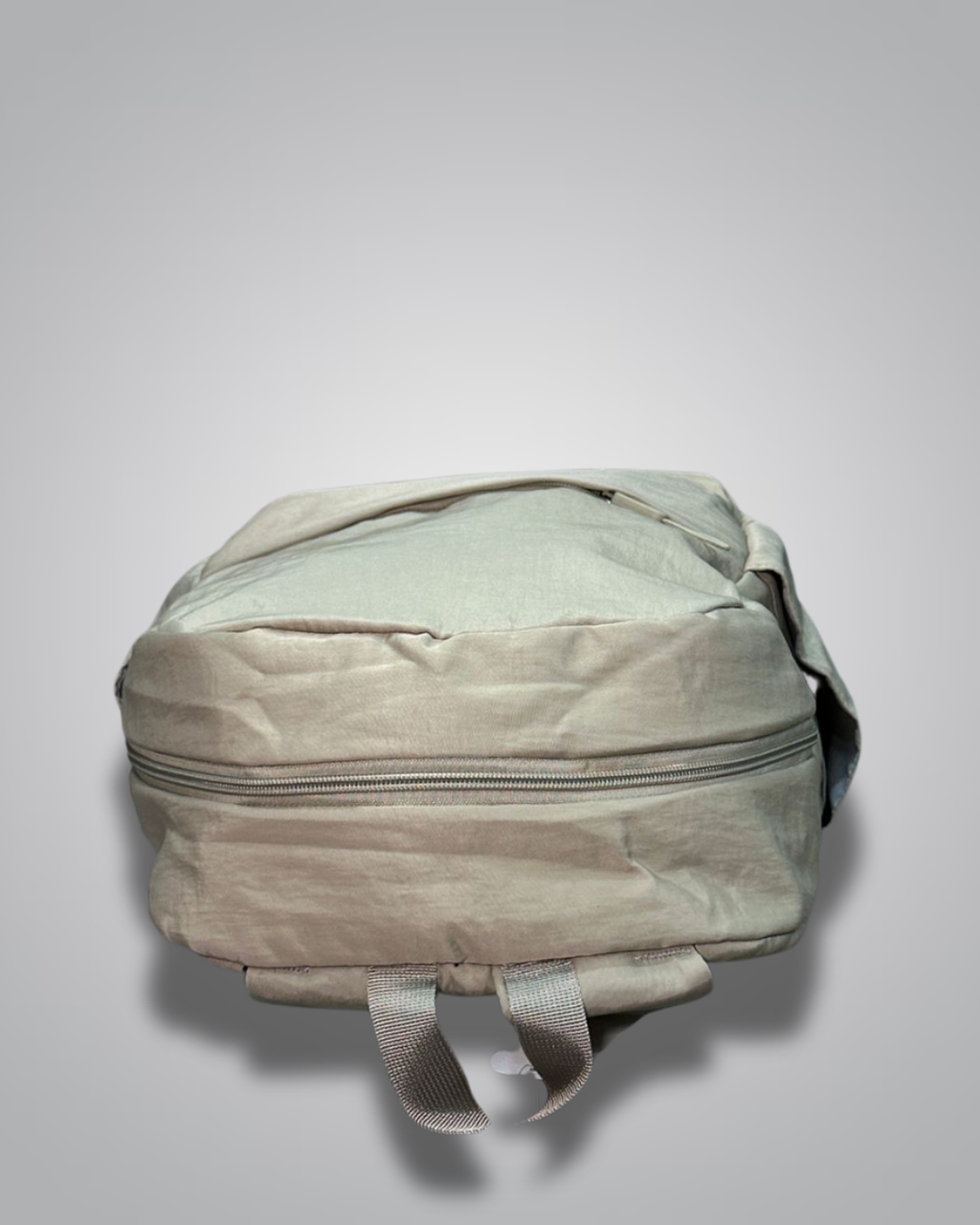 Light green backpack on a gray background- valentini impex