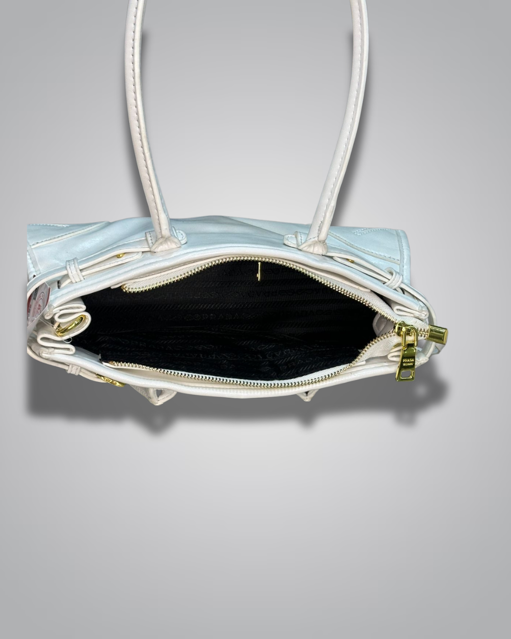 Clear handbag with a black interior on a gray background