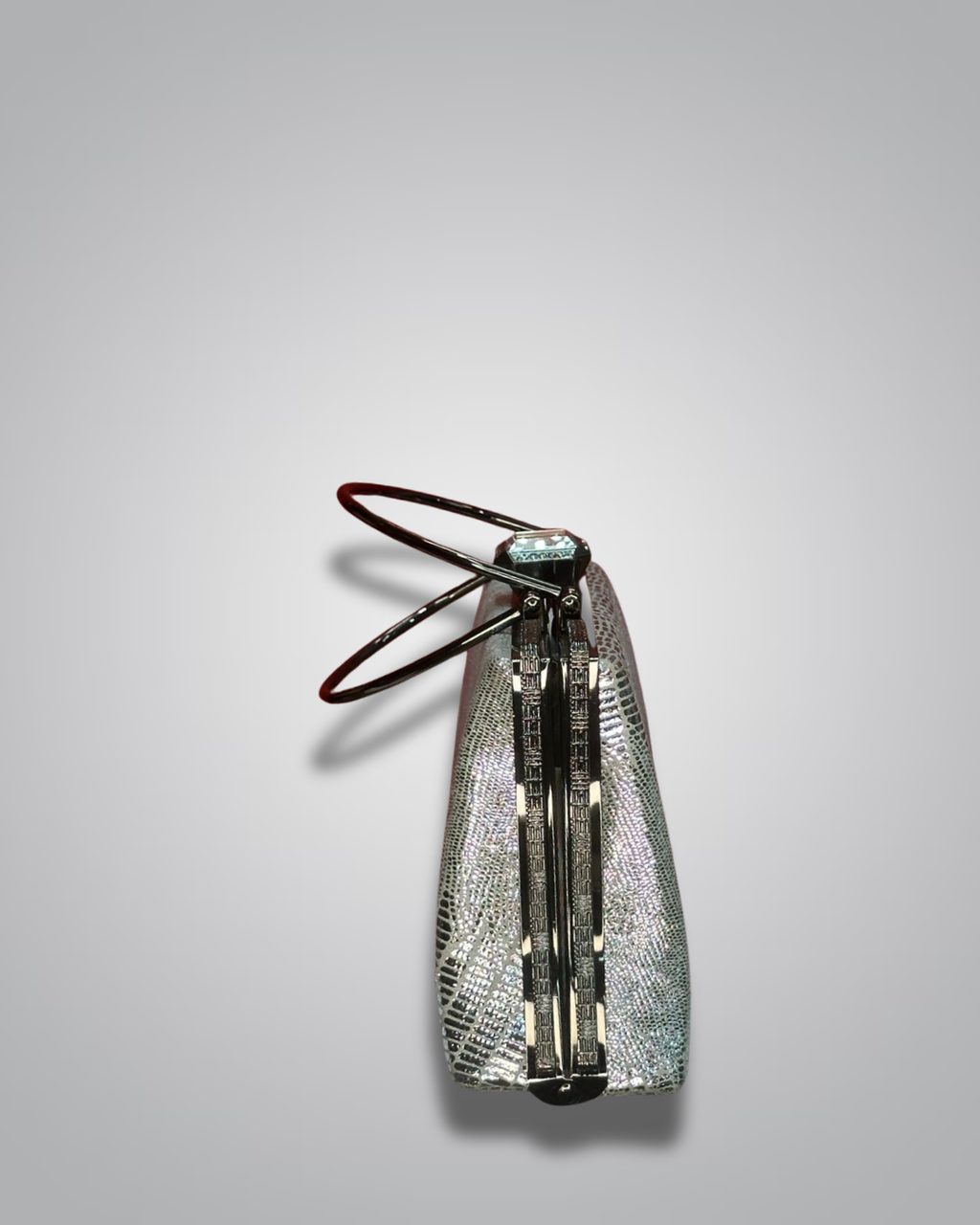 Vintage handbag with metallic sheen on a gray background- Valentino Impex