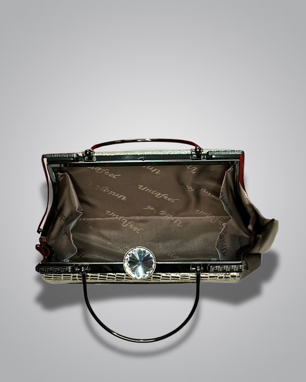 Vintage handbag with metallic sheen on a gray background- Valentino Impex