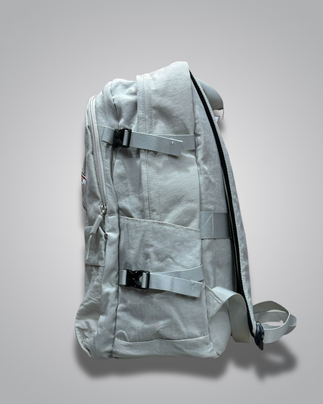 Light gray backpack with a visible brand label on a gray background- Valentino Impex
