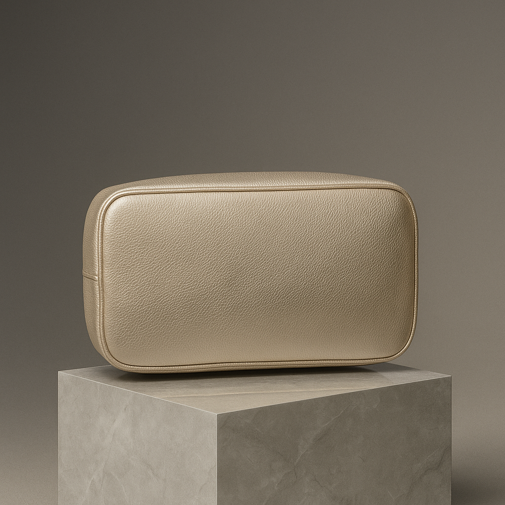 Beige leather pouch on a gray pedestal against a dark background