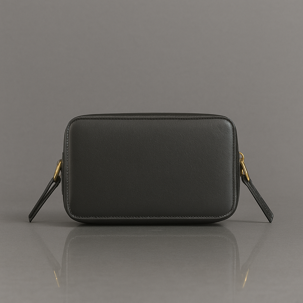 Black leather crossbody bag on a gray background