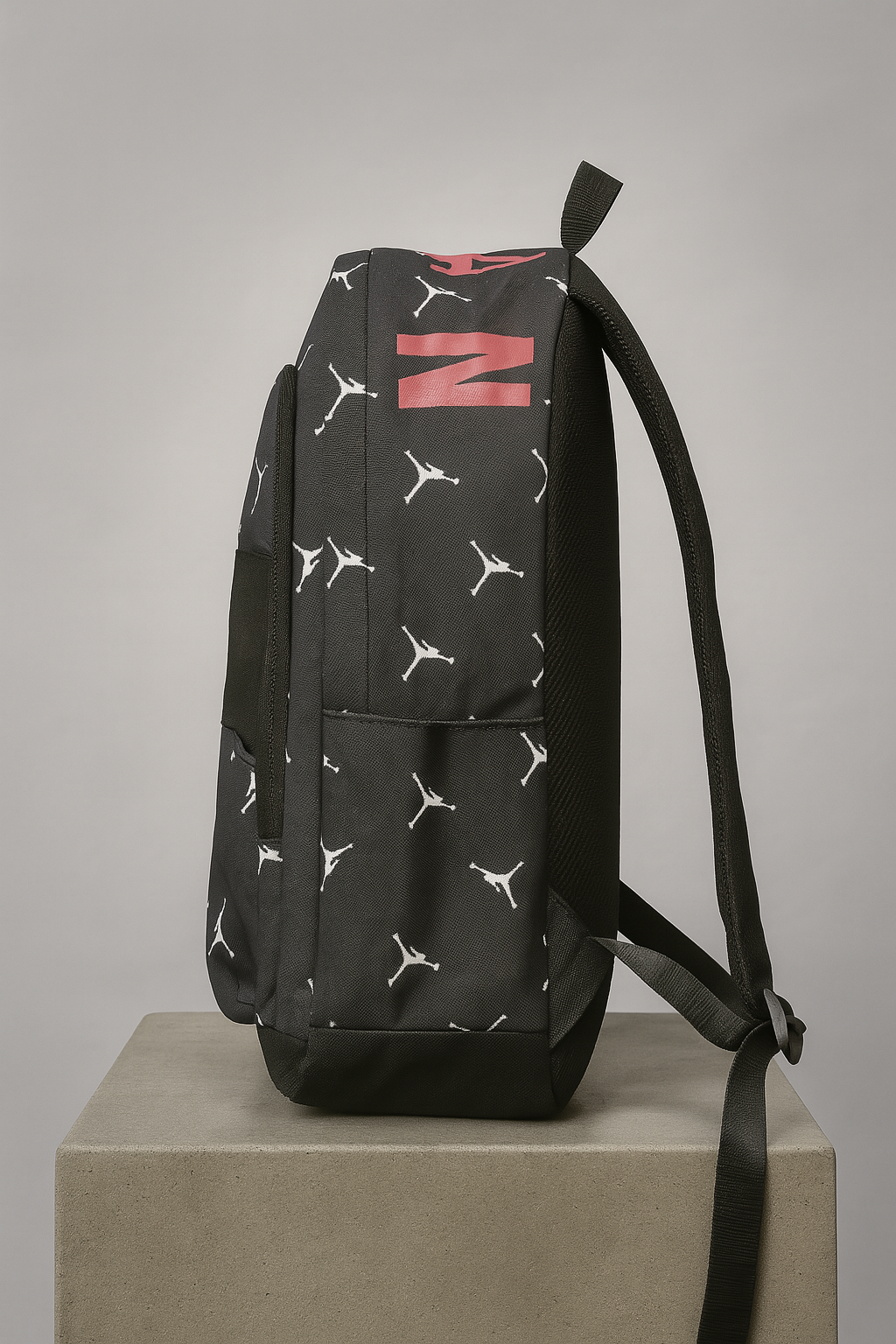 Black backpack with white and red patterns on a gray background
