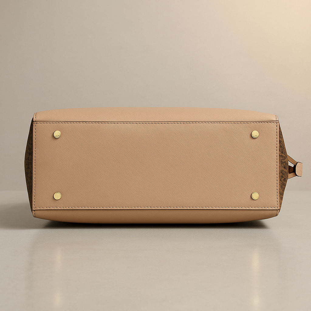 Beige handbag with gold accents on a beige background