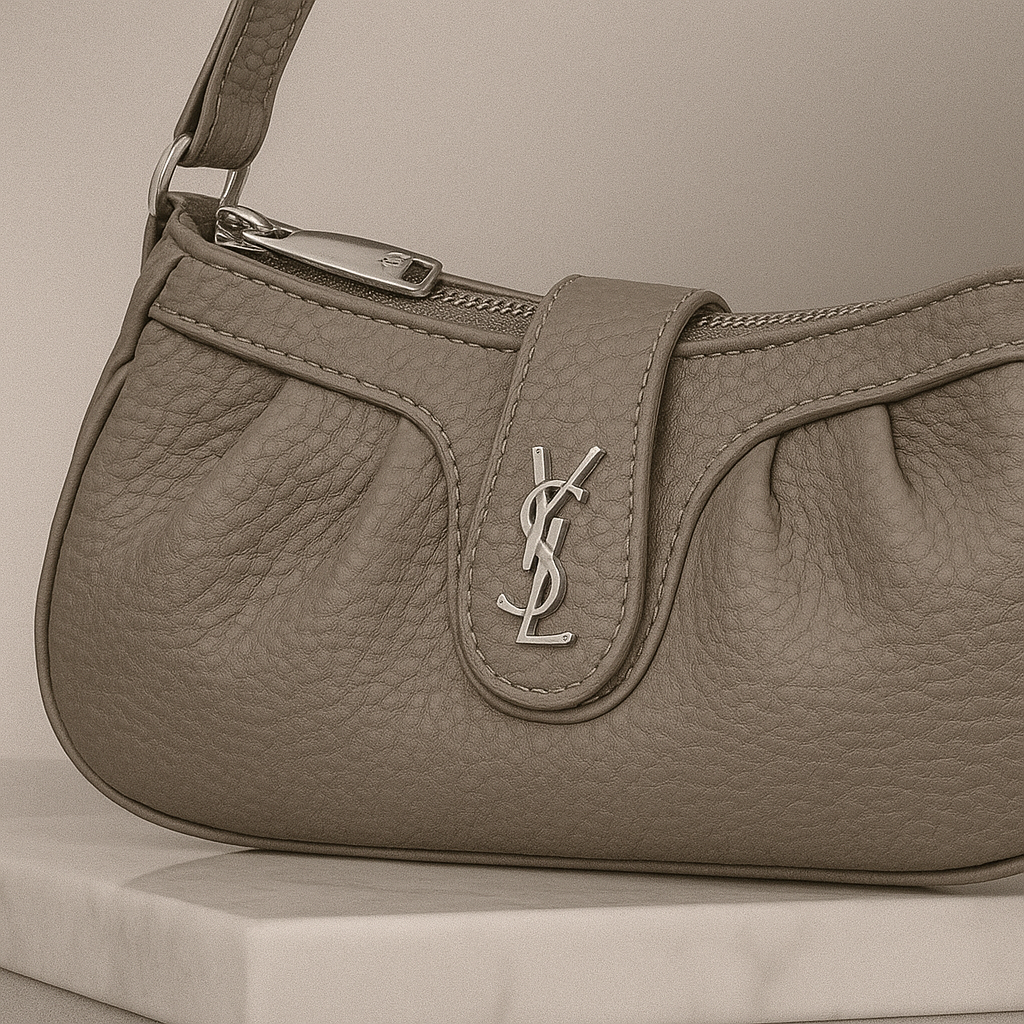Brown leather handbag with a brand logo on a neutral background