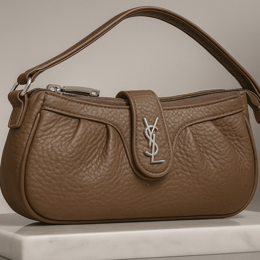Brown leather handbag with a prominent brand logo on a neutral background