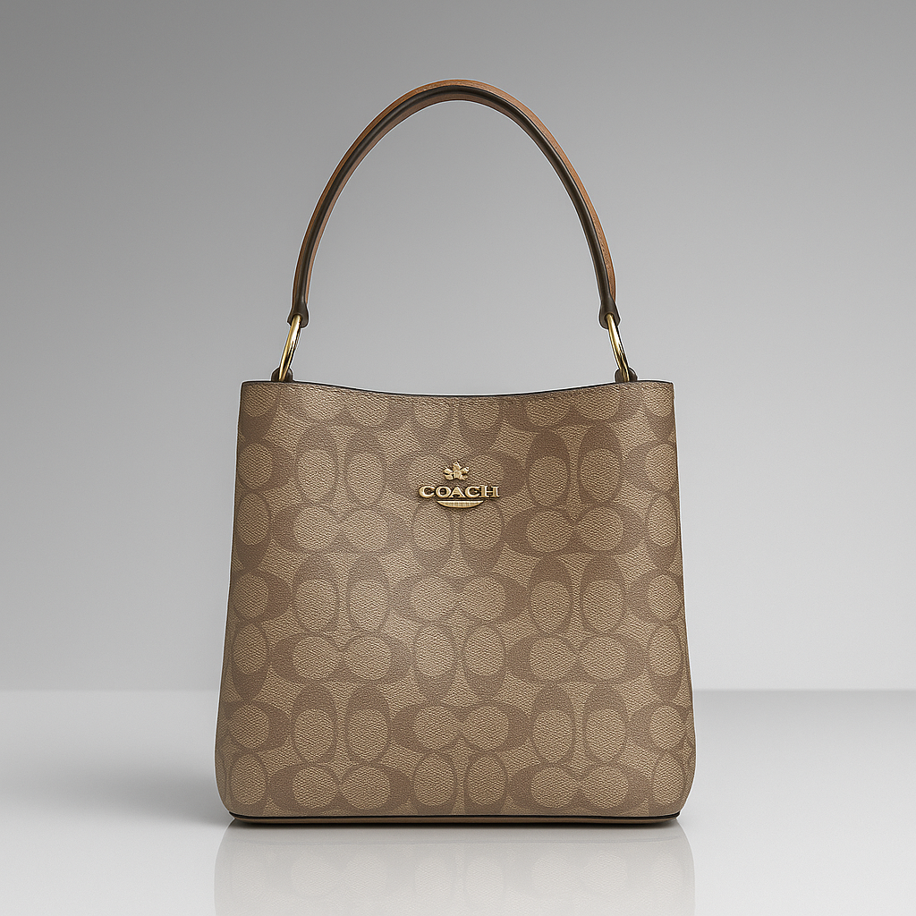 Beige handbag with brown handle on a gray background
